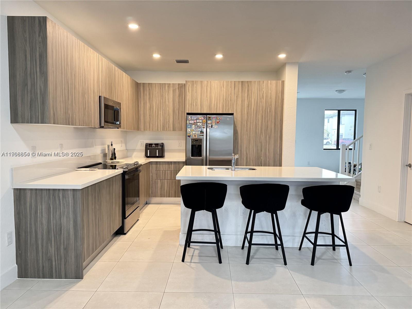 13627 Southwest 157th Court Miami, FL 33196 - Photo 8 of 26 a kitchen with a sink and cabinets
