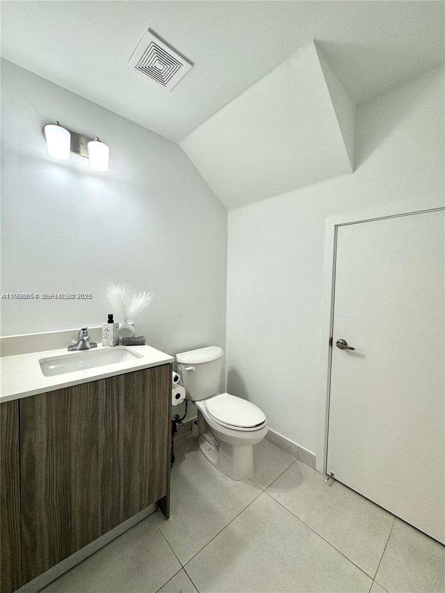 13627 Southwest 157th Court Miami, FL 33196 - Photo 9 of 26 a bathroom with a toilet sink and mirror