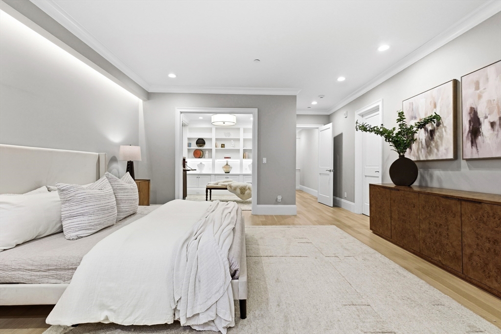 131 St Botolph Street, Unit 1 Boston, MA 02115 - Photo 15 of 29 a spacious bedroom with a bed a couch and potted plant on the dresser