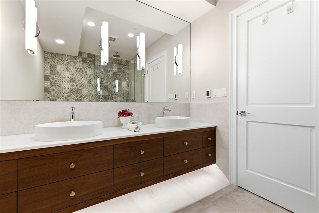 131 St Botolph Street, Unit 1 Boston, MA 02115 - Photo 18 of 29 a bathroom with a double vanity sink and mirror