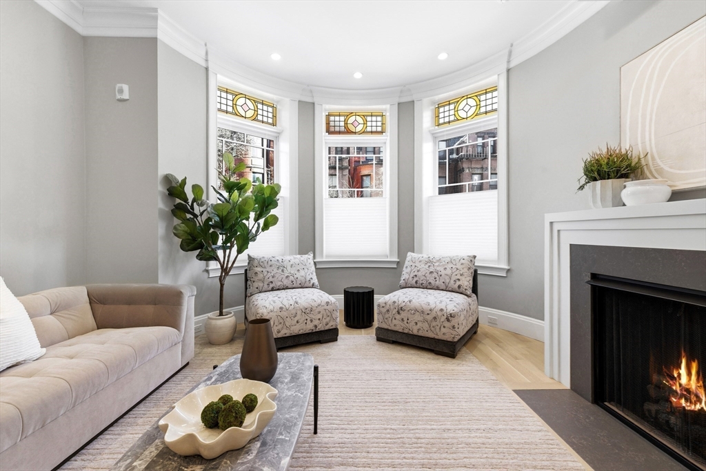 131 St Botolph Street, Unit 1 Boston, MA 02115 - Photo 2 of 29 a living room with furniture and a fireplace