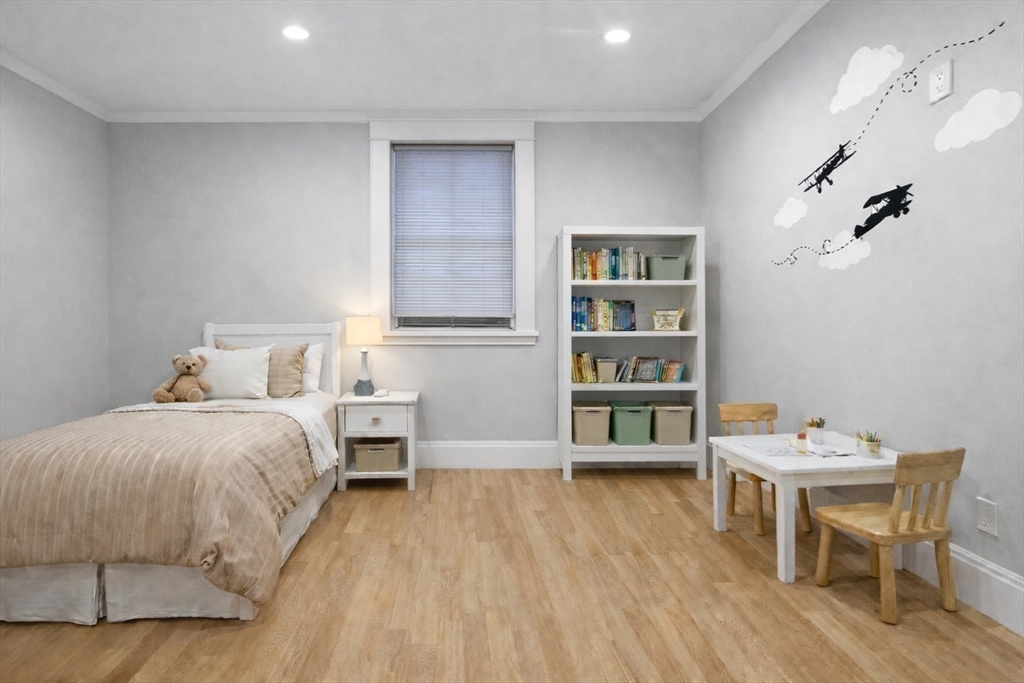 131 St Botolph Street, Unit 1 Boston, MA 02115 - Photo 22 of 29 a spacious bedroom with a bed and a table in it