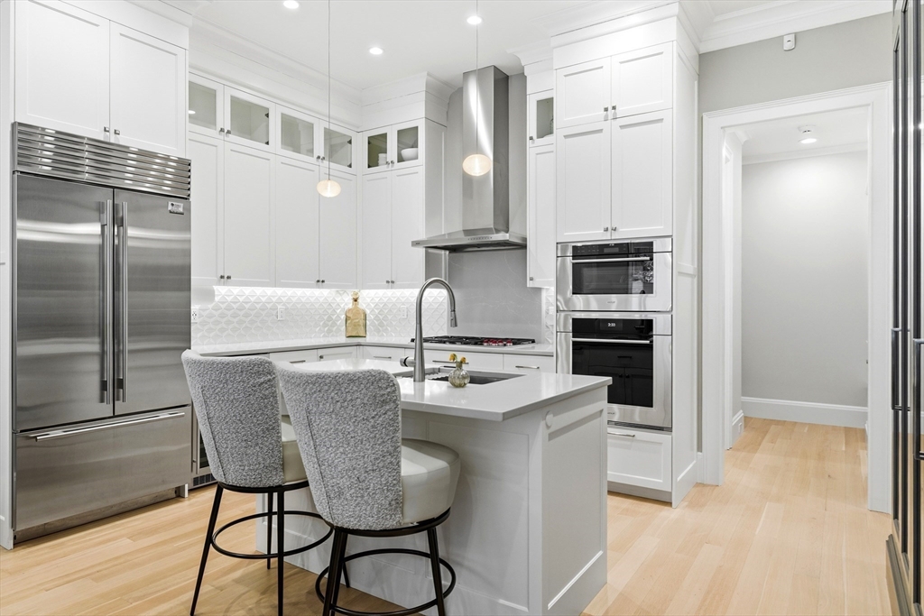 131 St Botolph Street, Unit 1 Boston, MA 02115 - Photo 4 of 29 a kitchen with stainless steel appliances granite countertop a sink a stove a refrigerator and island