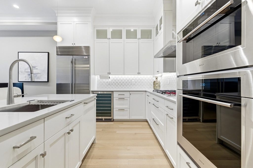 131 St Botolph Street, Unit 1 Boston, MA 02115 - Photo 5 of 29 a kitchen with granite countertop a sink and stainless steel appliances