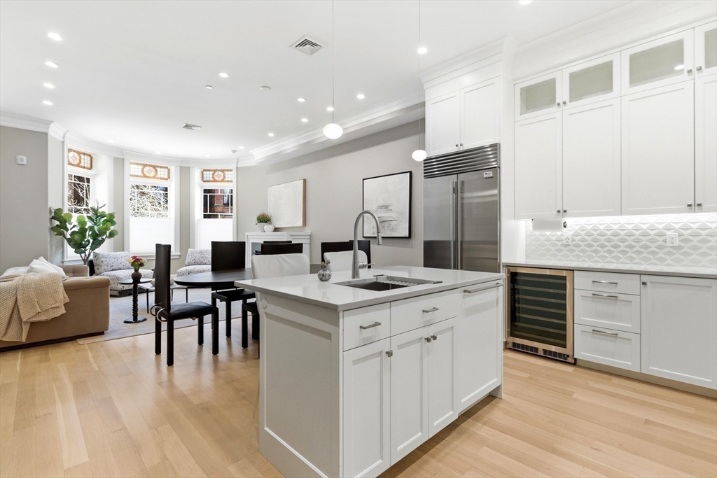 131 St Botolph Street, Unit 1 Boston, MA 02115 - Photo 6 of 29 a kitchen with white cabinets and sink