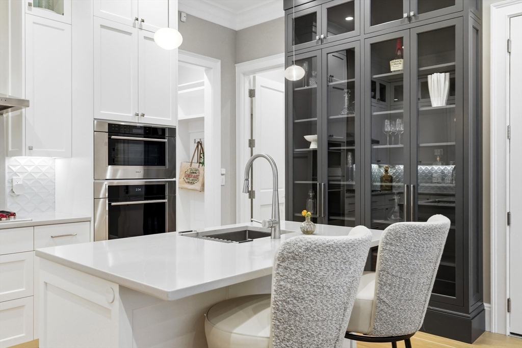 131 St Botolph Street, Unit 1 Boston, MA 02115 - Photo 8 of 29 a kitchen with a refrigerator a oven and white cabinets