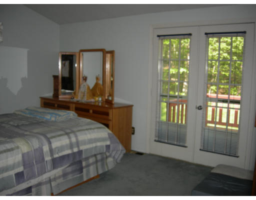 541 Reservoir Road Lunenburg, MA 01462 - Photo 13 of 24 a bedroom with a large bed and a window