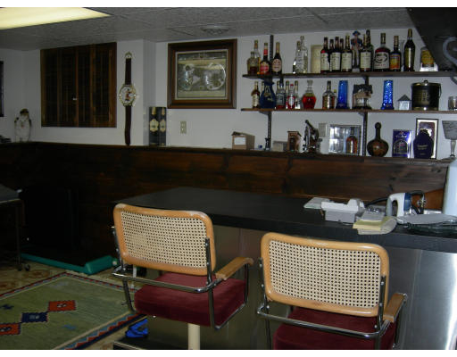 541 Reservoir Road Lunenburg, MA 01462 - Photo 17 of 24 a room with two chair a table and a book shelf