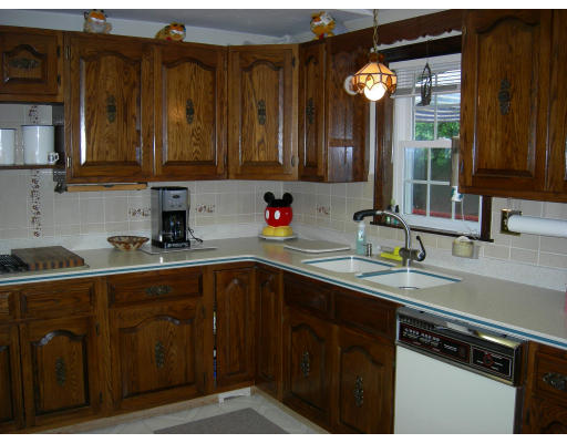 541 Reservoir Road Lunenburg, MA 01462 - Photo 19 of 24 a kitchen with granite countertop a sink dishwasher stove and cabinets
