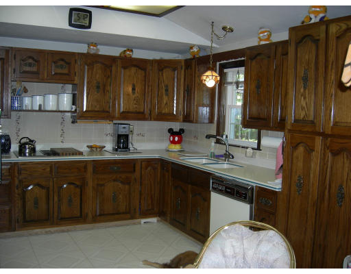 541 Reservoir Road Lunenburg, MA 01462 - Photo 9 of 24 a kitchen with stainless steel appliances granite countertop a sink a stove and a wooden cabinets