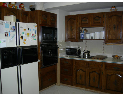 541 Reservoir Road Lunenburg, MA 01462 - Photo 10 of 24 a kitchen with stainless steel appliances a refrigerator and cabinets