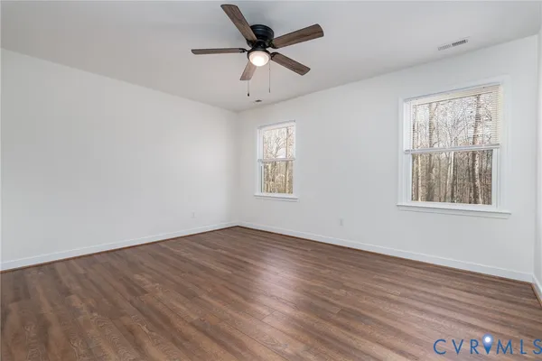 wooden floor in an empty room with a window