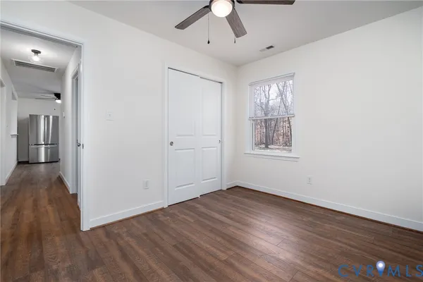 wooden floor in an empty room with a window