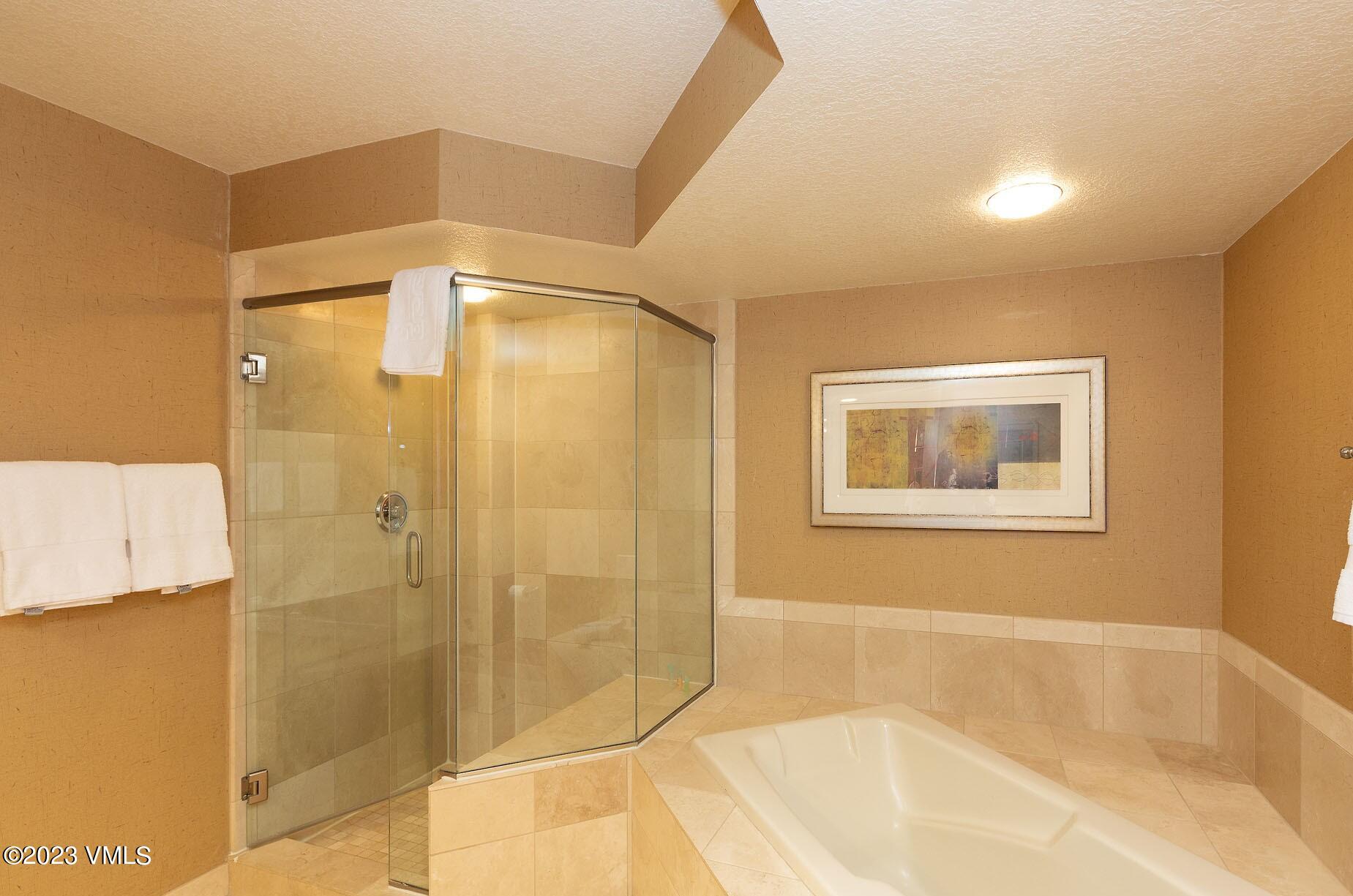 210 Offerson Road, Unit R408 WEEKS 33/34/35 Beaver Creek, CO 81620 - Photo 21 of 28 a bathroom with a bathtub and shower
