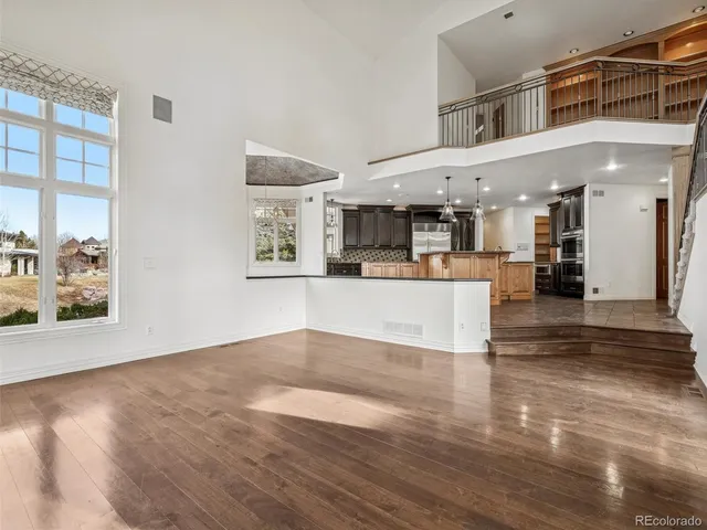 a living room with furniture a large window and a fireplace