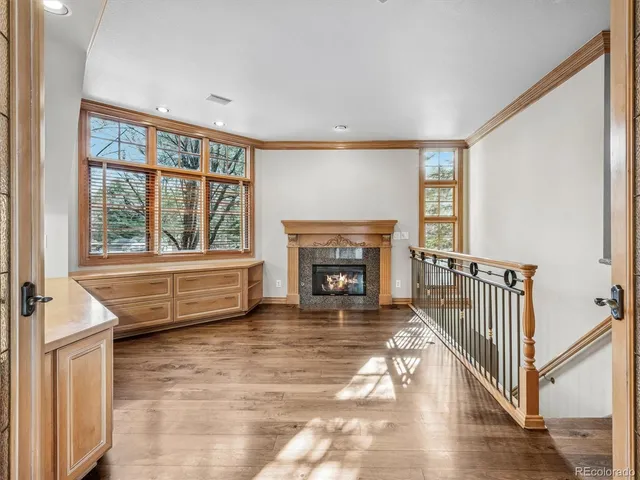 a living room with furniture a fireplace and a large window