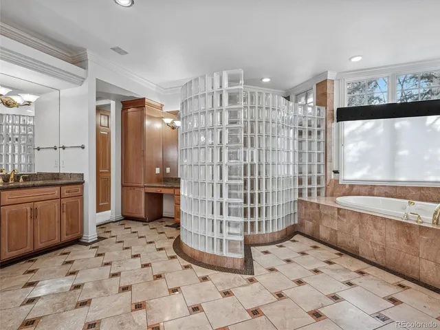 a bathroom with a sink a large mirror and a shower