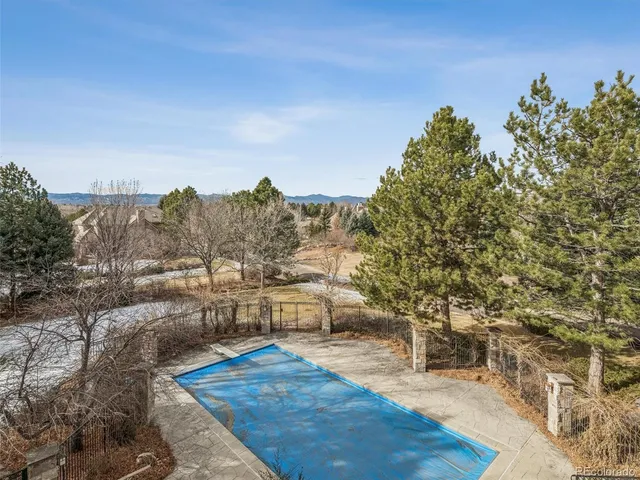 a living room with furniture a fireplace and a dining table with wooden floor