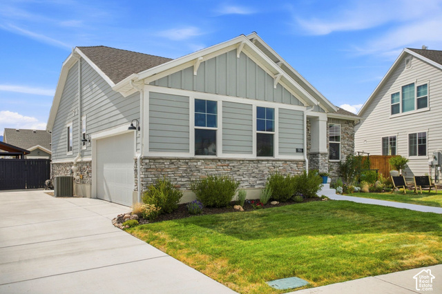 986 South Old Farm Road Heber City, UT 84032 - Photo 43 of 51 Light gray siding exterior with stone veneer accents, an attached garage, landscaped front yard, and a concrete driveway
