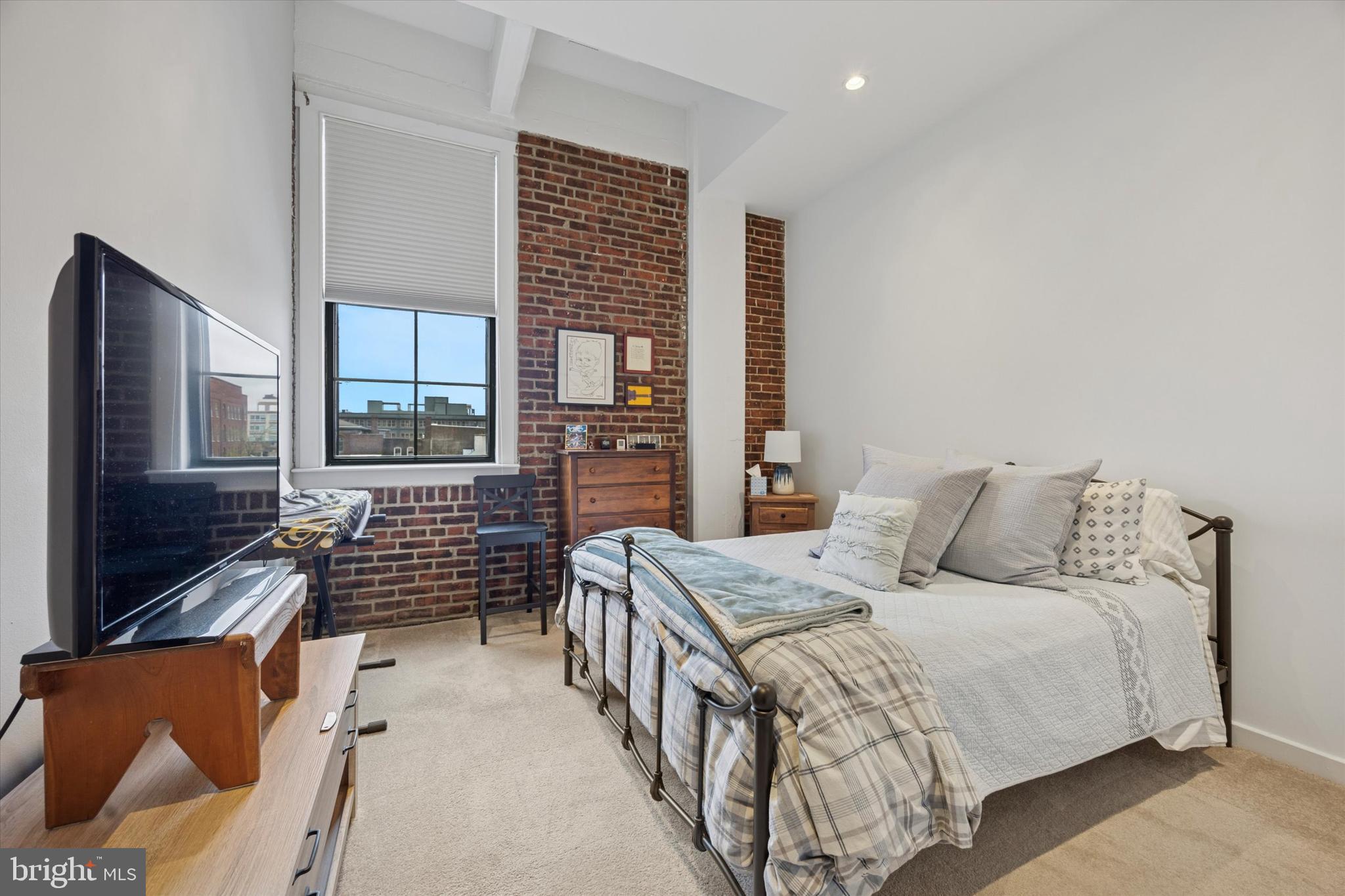 315 New Street, Unit 417 Philadelphia, PA 19106 - Photo 15 of 29 a bedroom with a large bed and a flat screen tv