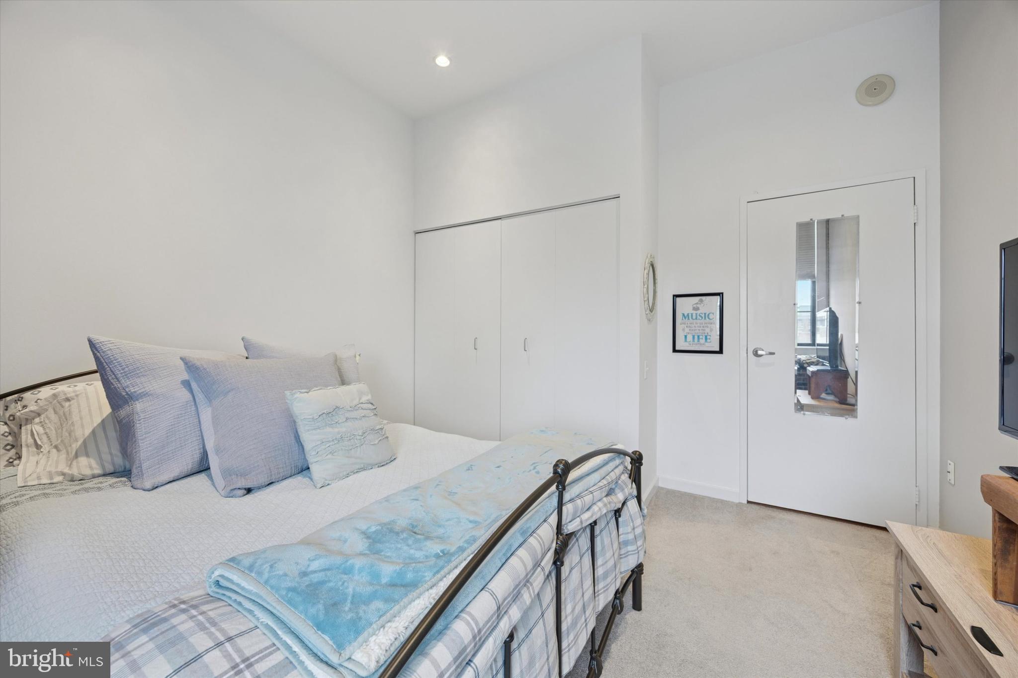 315 New Street, Unit 417 Philadelphia, PA 19106 - Photo 17 of 29 a bedroom with a bed and a table
