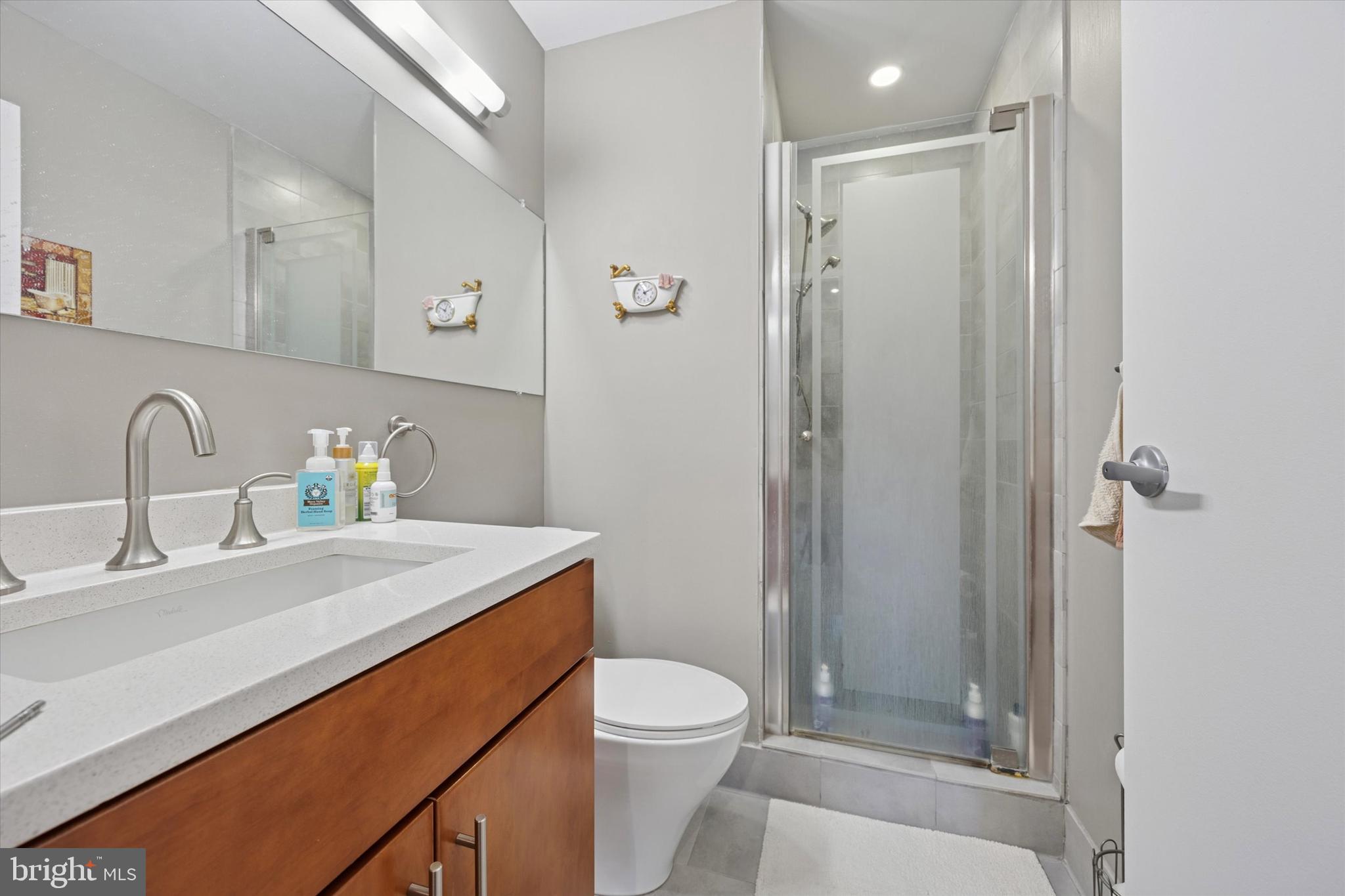 315 New Street, Unit 417 Philadelphia, PA 19106 - Photo 18 of 29 a bathroom with a sink a toilet and shower