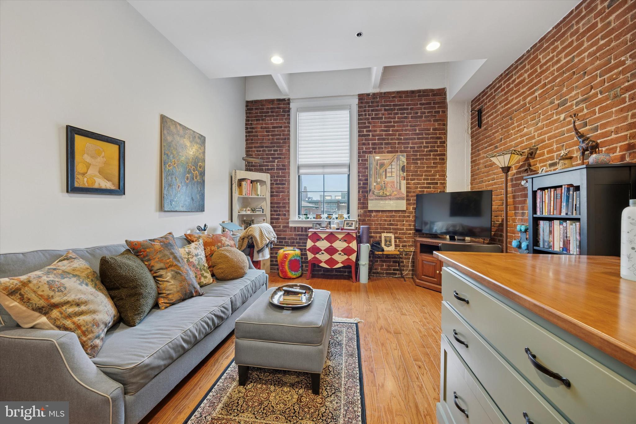 315 New Street, Unit 417 Philadelphia, PA 19106 - Photo 6 of 29 a living room with furniture and a flat screen tv