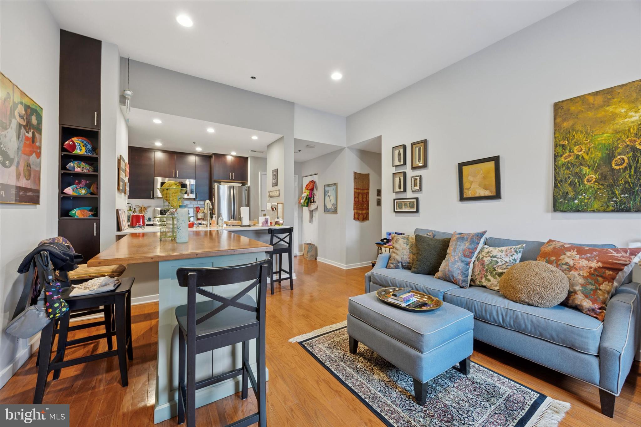 315 New Street, Unit 417 Philadelphia, PA 19106 - Photo 9 of 29 a living room with furniture and kitchen view