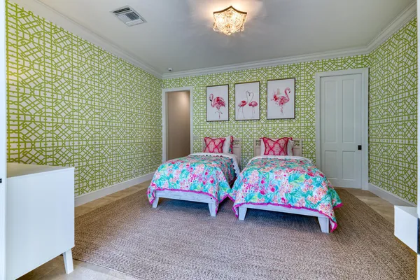 a bedroom with a bed and a baby crib with wooden floor