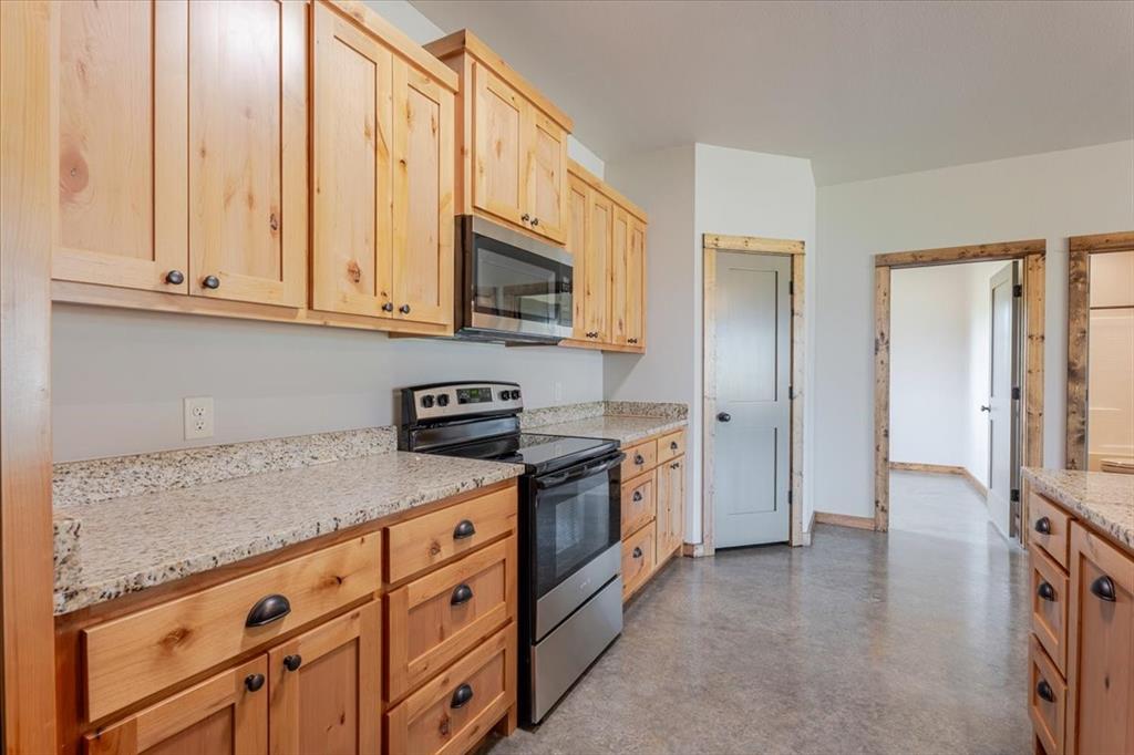 11 Maverick Loop Granbury, TX 76048 - Photo 12 of 27 a kitchen with stainless steel appliances granite countertop a stove a sink and a refrigerator