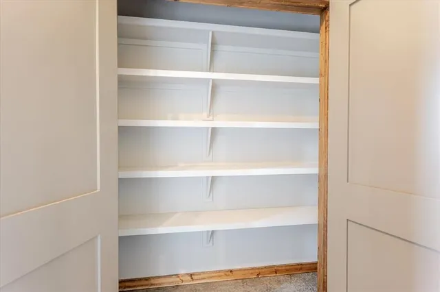 an empty room with fan and windows