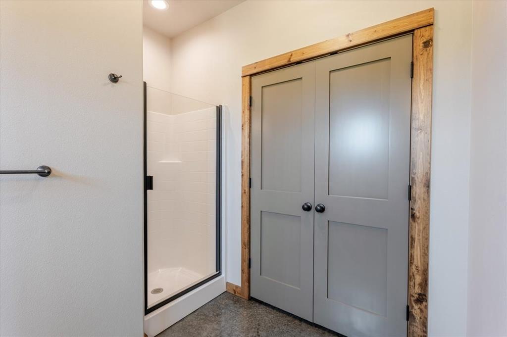 11 Maverick Loop Granbury, TX 76048 - Photo 18 of 27 a view of a bathroom with a glass shower door