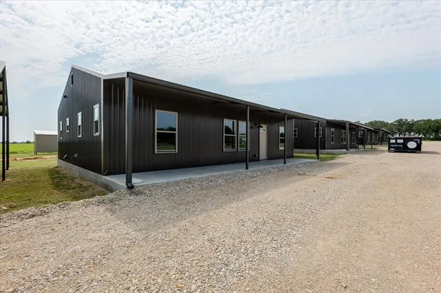a view of a house with a wooden fence