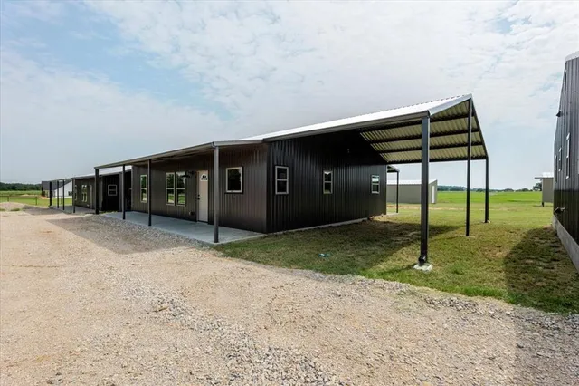 a backyard of a house with barbeque oven