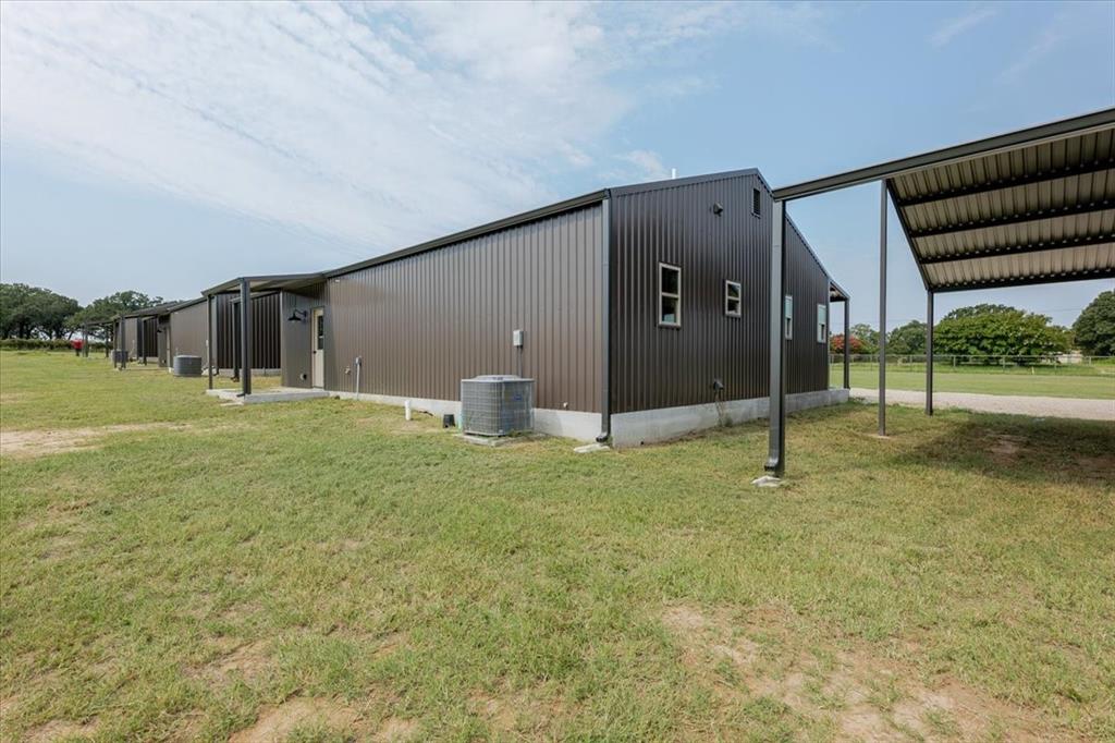11 Maverick Loop Granbury, TX 76048 - Photo 4 of 27 a backyard of a house with a yard and tree