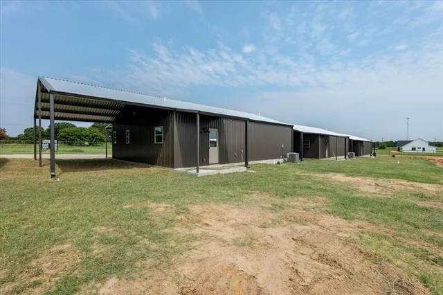 a view of house with backyard and glass door