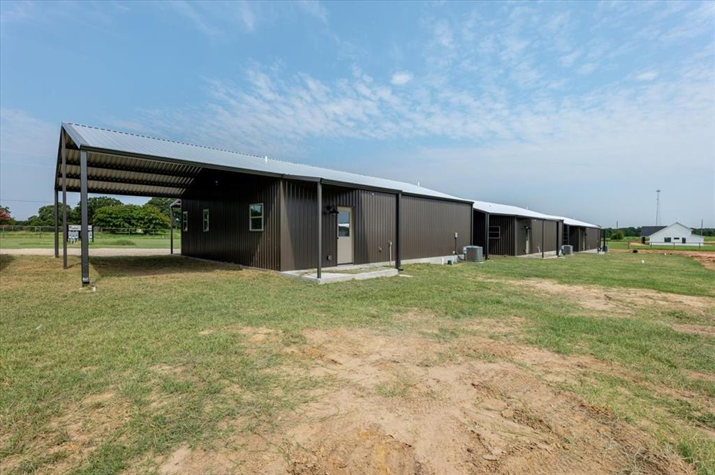 11 Maverick Loop Granbury, TX 76048 - Photo 5 of 27 a view of house with backyard and glass door