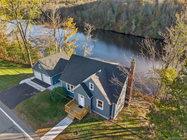 an aerial view of a house with garden space and street view