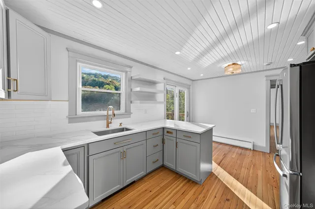a kitchen with a sink cabinets and wooden floor