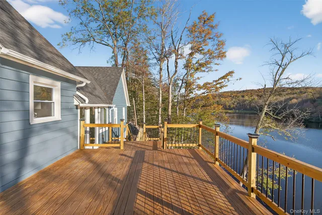 a view of balcony with wooden floor and fence