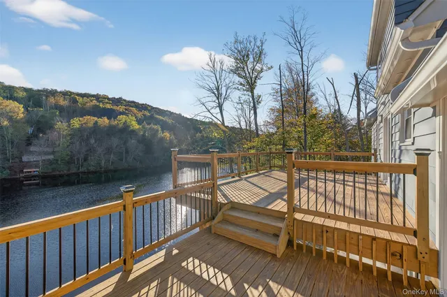 a view of a balcony with wooden fence and floor