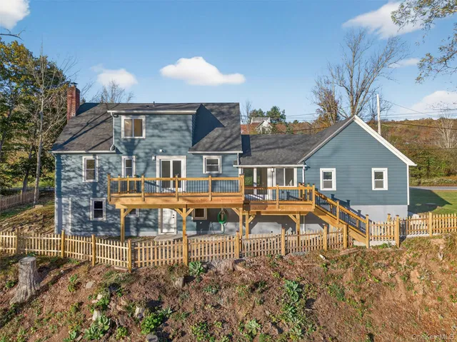 a view of a house with backyard and sitting area