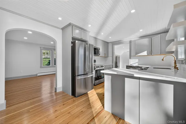 a kitchen with a refrigerator a sink and cabinets