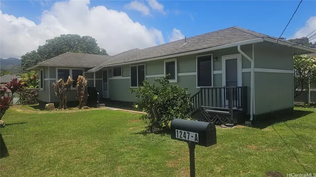 a front view of house with yard and trees
