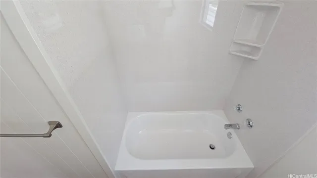 a white bath tub sitting next to a white sink