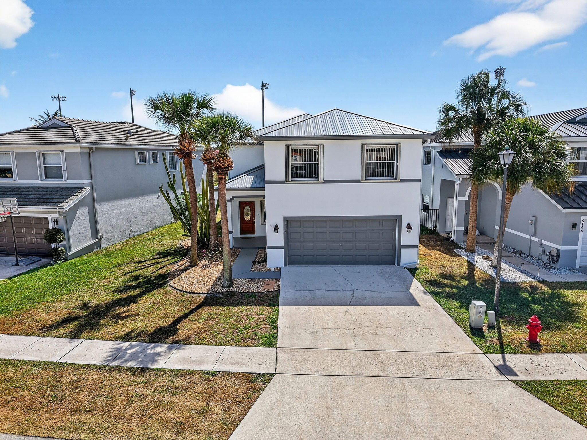 6140 Spring Isles Boulevard Lake Worth, FL 33463 - Photo 2 of 66 56-web-or-mls-DJI_20260225125036_0291_D