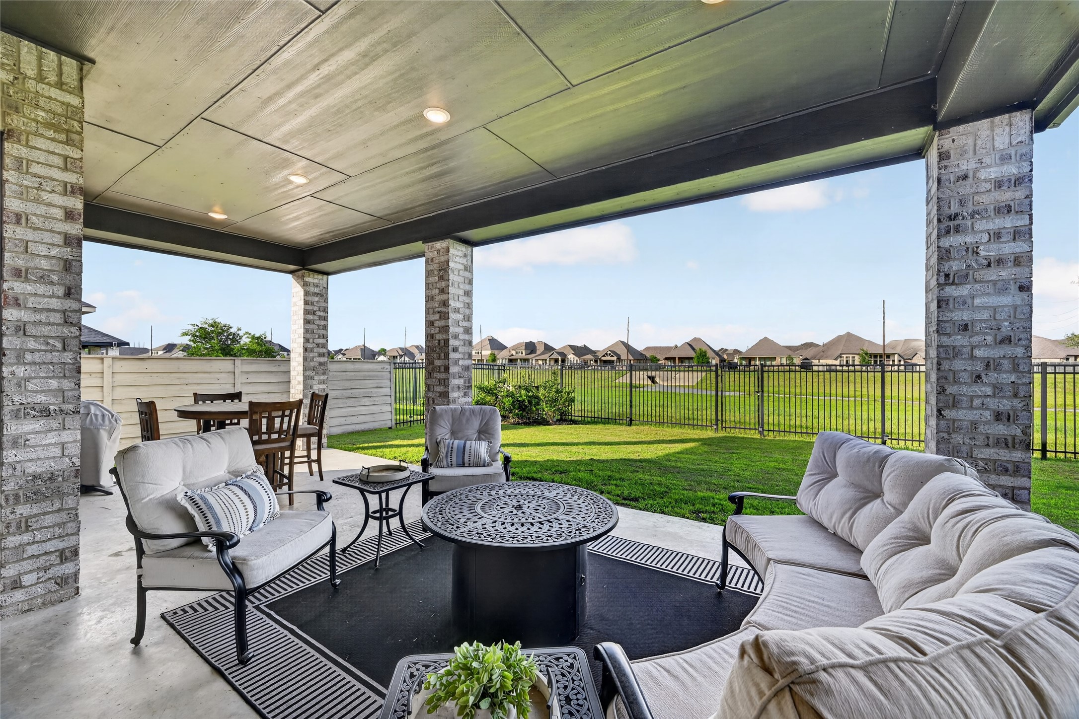 4439 Stone Ridge Lane Manvel, TX 77578 - Photo 47 of 48 a view of a patio with couches potted plants and a big yard