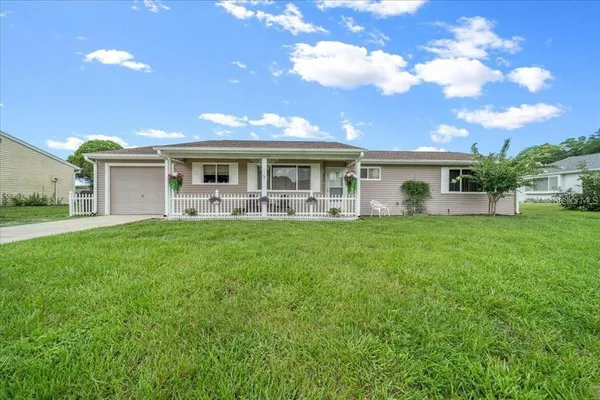 a front view of house with yard and green space
