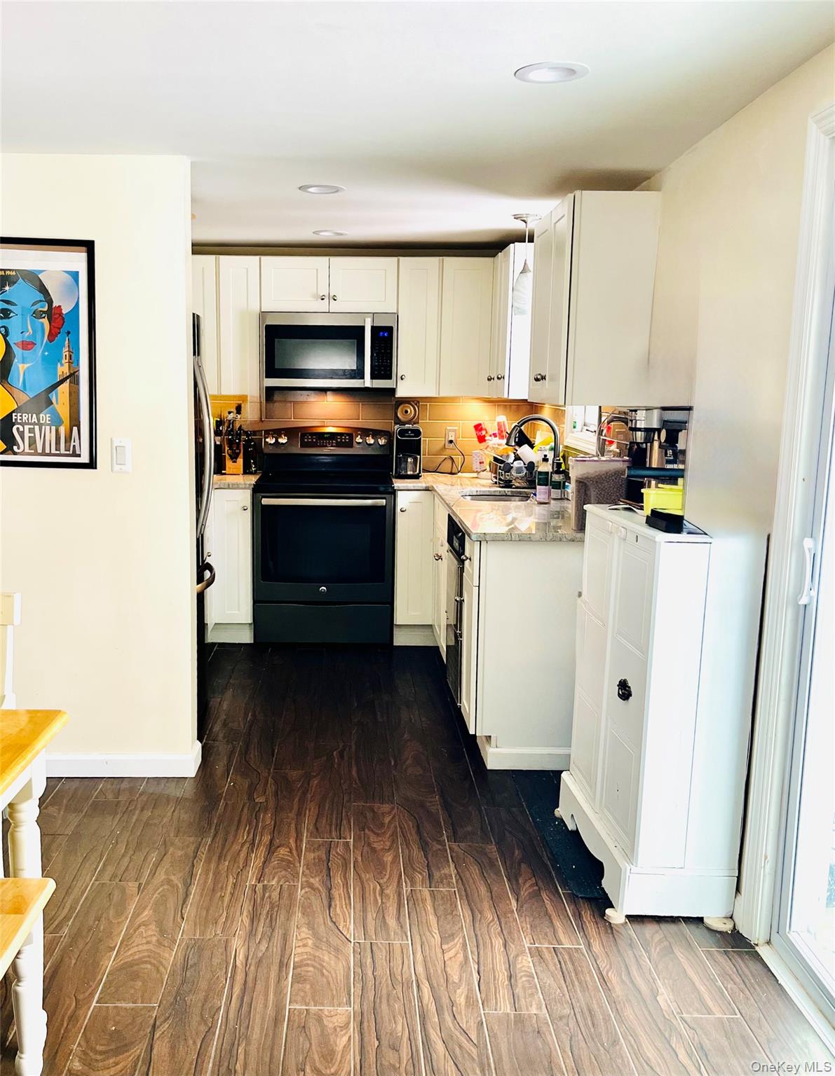 72 Lakeside Road Mahopac, NY 10541 - Photo 3 of 31 Kitchen featuring electric range oven, stainless steel microwave, a sink, and white cabinets