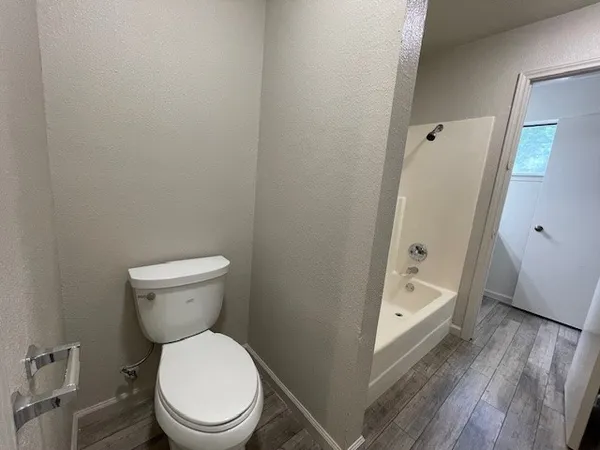 a white toilet sitting next to a bathroom sink